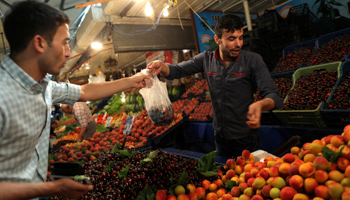 A man buying cherries in a market in Ankara, June 25 (Reuters/Stoyan Nenov)