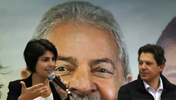 PT candidate Fernando Haddad and running-mate Manuela D'avila in front of a photo of Lula da Silva (Reuters/Paulo Whitaker)