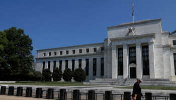 A person walks past the Federal Reserve building in Washington, US (Reuters/Leah Millis)