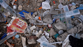 Needles used for shooting heroin and other opioids along with other paraphernalia litter the ground in a park in the Kensington section of Philadelphia, Pennsylvania, US (Reuters/Charles Mostoller)