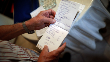 Greek pensioner Yorgos Vagelakos lists debts to the local pharmacy, August 14 (Reuters/Alkis Konstantinidis)