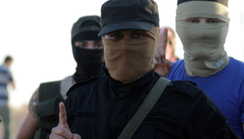 Salafi-jihadist fighters from al-Qaida-linked Hayat Tahrir al-Sham are seen in Syria, July 18, 2018 (Reuters/Khalil Ashawi)