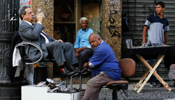 A businessman having his shoes shined in Sao Paulo (Reuters/Nacho Doce)