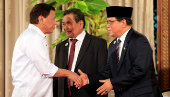 President Rodrigo Duterte (left) with the MILF’s Murad Ebrahim (right) and Mohagher Iqbal (centre) at the handover of the draft BOL (Reuters/Romeo Ranoco)