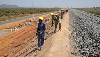 Construction workers work on the new standard gauge railway line near Voi town, Kenya, March 16, 2016 (Reuters/Goran Tomasevic)