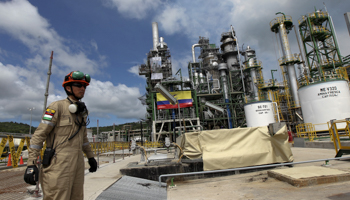 Oil workers are seen in front of a refurbished oil refinery in Esmeraldas, Ecuador (Reuters/Guillermo Granja)