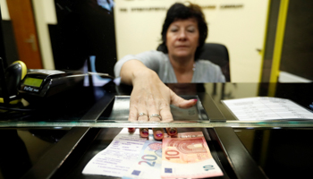 Exchanging forints for euros at a currency exchange shop in Esztergom, Hungary (Reuters/Laszlo Balogh)