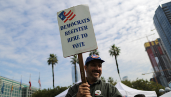 A Democratic Party worker encourages new US citizens to vote in the coming midterm elections outside a naturalization ceremony, Los Angeles, March 20 (Reuters/Lucy Nicholson)