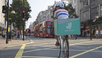 A cyclist delivers food for Deliveroo in London (Reuters/Toby Melville)