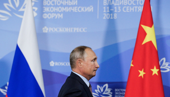 President Vladimir Putin between the Russian and Chinese flags (Reuters/Vladimir Smirnov/TASS)