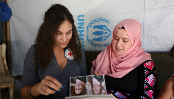 Syrian refugee Hana al-Ali, 30, with Sarah Joe Chamate, a psychologist with the International Committee of Red Cross (ICRC), in Bar Elias town, in the Bekaa valley, Lebanon July 20, 2018 (Reuters/Aziz Taher)