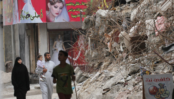 People in Raqqa walk among rubble of ruined buildings, October 12 (Reuters/Aboud Hamam)