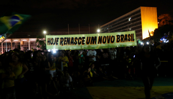 Supporters of Jair Bolsonaro with a banner reading “A new Brazil is reborn today” (Reuters/Adriano Machado)