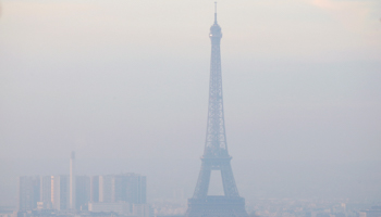The Eiffel Tower is surrounded by a small-particle haze which hangs above the skyline in Paris (Reuters/Gonzalo Fuentes)