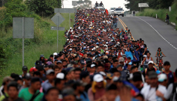 Migrants, part of a caravan travelling from Central America en route to the United States walk by the road that links Ciudad Hidalgo with Tapachula, Mexico, November 2 (Reuters/Carlos Garcia Rawlins)