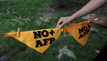 Banners reading "no more pension fund administrators" at an October protest (Reuters/Ivan Alvarado)