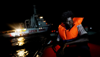 A migrant from Dafur sits on board a rescue boat in the central Mediterranean Sea, August 2, 2018. He and his son traveled from Sudan to Libya where they escaped a kidnapping that killed 22 people (Reuters/Juan Medina)