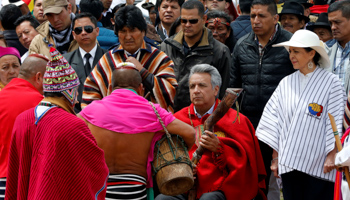 Ecuadorean indigenous groups perform during a traditional ceremony for Ecuador's President Lenin Moreno (C) as Moreno's wife Rocio Gonzalez (R) and Bolivia's President Evo Morales (L) look on in Cochasqui, Ecuador, May 25, 2017 (Reuters/Henry Romero)