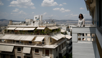 A potential Chinese buyer on the balcony of an apartment in central Athens, May 2018 (Reuters/Costas Baltas)