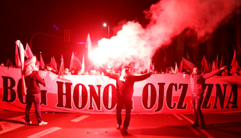 Marchers with the banner, "God, Honour, Fatherland" set off flares at the commemoration of the 100th anniversary of Polish independence in Warsaw, November 11 (Reuters/Kacper Pempel)