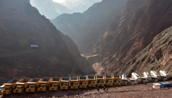 Construction trucks on top of the Roghun dam in Tajikistan (Reuters/Nozim Kalandarov)