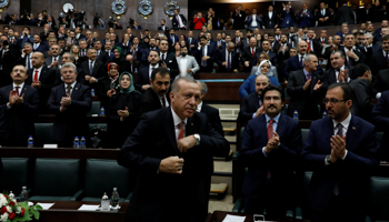 President Erdogan gets up to address the AKP parliamentary party (AKP) in Ankara, November 27 (Reuters/Umit Bektas)