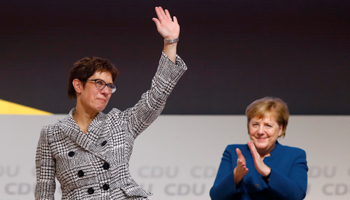 Annegret Kramp-Karrenbauer waves next to German Chancellor Angela Merkel after being elected as the party leader during the Christian Democratic Union (CDU) party congress in Hamburg, Germany, December 7, 2018 (Reuters/Kai Pfaffenbach)