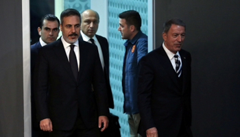 Turkish Defence Minister Hulusi Akar (R) and National Intelligence Organisation chief Hakan Fidan arrive for the news conference after the German-French-Turkish-Russian Syria summit, Istanbul, October 27 (Reuters/Arif Hudaverdi Yaman)
