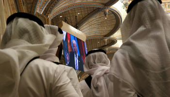 People watch US President Donald Trump deliver an address to the Arab Islamic American Summit in Riyadh, May 2017 (Reuters/Jonathan Ernst)