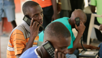 Haitians use satellite phones provided by Telecoms Sans Frontiers after the 2008 tropical storms and flooding (Reuters/Eduardo Munoz)