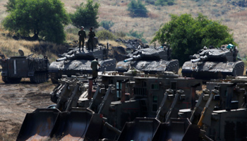 Israeli soldiers stand on tanks in the annexed Golan Heights on the border with Syria, May 2018 (Reuters/Ronen Zvulun)