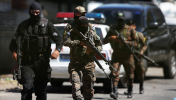 Salvadoran policemen and soldiers secure the area where according to local media, a policeman and two gang members were killed, during a patrol in San Salvador, El Salvador, February 2 (Reuters/Jose Cabezas)