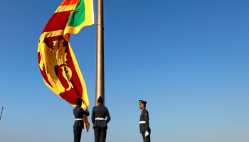 Military members raising the national flag (Reuters/Dinuka Liyanawatte)