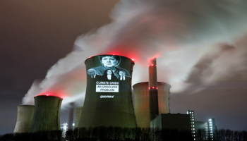 Greenpeace activists project images of German Chancellor Angela Merkel (top), German Economy minister Peter Altmaier, SPD chairwoman Andrea Nahles and German Transport minister Andreas Scheuer (L-R) with a slogan onto a cooling tower of the brown coal power plant of RWE, one of Europe's biggest utilities in Neurath, north-west of Cologne, Germany, December 14, 2018 (Reuters/Wolfgang Rattay)