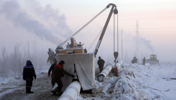 Gazprom workers fitting a gas pipeline section in Siberia (Reuters/Denis Sinyakov)