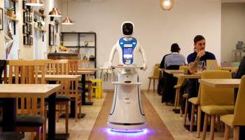 A robot waiter serves customers at a cafe in Budapest, Hungary, January 24 (Reuters/Bernadett Szabo)