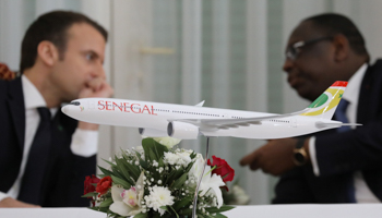 A model of a Senegal Air passenger jet is seen as Senegalese President Macky Sall speaks with French President Emmanuel Macron in Dakar, February 2018 (Reuters/Ludovic Marin)