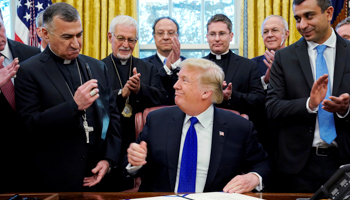 US President Donald Trump signs the Iraq and Syria Genocide Relief and Accountability Act, December 2018 (Reuters/Jonathan Ernst)