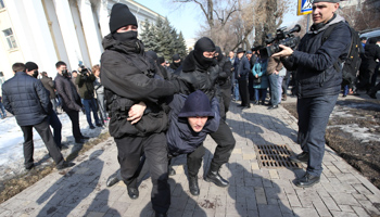 Police detain a participant in a February 27 protest in Almaty (Reuters/Pavel Mikheyev)