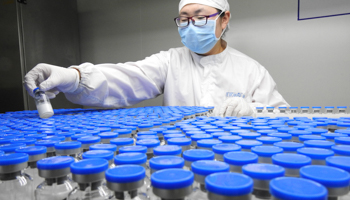 A technician inspects anti-cancer drugs in vials at a lab of a pharmaceutical company in Lianyungang, Jiangsu province, China, March 13, 2019 (Reuters/China Stringer Network)