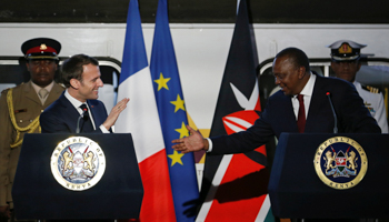 French President Emmanuel Macron greets Kenya's President Uhuru Kenyatta in Nairobi, March 13 (Reuters/Thomas Mukoya)