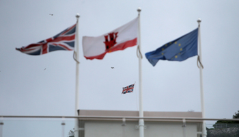 The Union Jack, the Gibraltarian flags and the European Union flag are seen flying in the British overseas territory of Gibraltar, historically claimed by Spain, November 25, 2018 (Reuters/Jon Nazca)