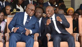 Democratic Republic of Congo's outgoing President Joseph Kabila sits next to his successor Felix Tshisekedi during an inauguration ceremony on January 24 (Reuters/Olivia Acland) 