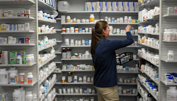 A technician stocks the shelves of the pharmacy at White House Clinic in Berea, Kentucky, US, February 2018 (Reuters/Bryan Woolston)