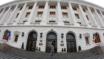 A man walks in front of Romania's Central Bank headquarters in Bucharest (Reuters/Bogdan Cristel)