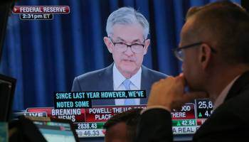 A trader watches US Federal Reserve Chairman Jerome Powell on a screen during a news conference (Reuters/Brendan McDermid)