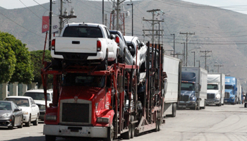 A car carrier transports Toyota trucks for delivery while waiting in queue for border customs control to cross into the US, at the Otay border crossing in Tijuana, Mexico, April (Reuters/Jorge Duenes)