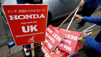 A placard is seen beside a pile of anti-Brexit ones as employees stage a rally against the planned closure of the Swindon plant of the Japanese car manufacturer, outside of the Houses of Parliament in London, Britain, March 6, 2019 (Reuters/Toby Melville)