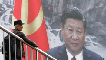 A TV screen shows a live news broadcast of Chinese President Xi Jinping at a subway station in Beijing  (Reuters/Tyrone Siu)