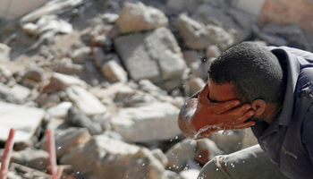 A labourer washes his face at a slum being demolished in Cairo (Reuters/Amr Abdallah Dalsh)